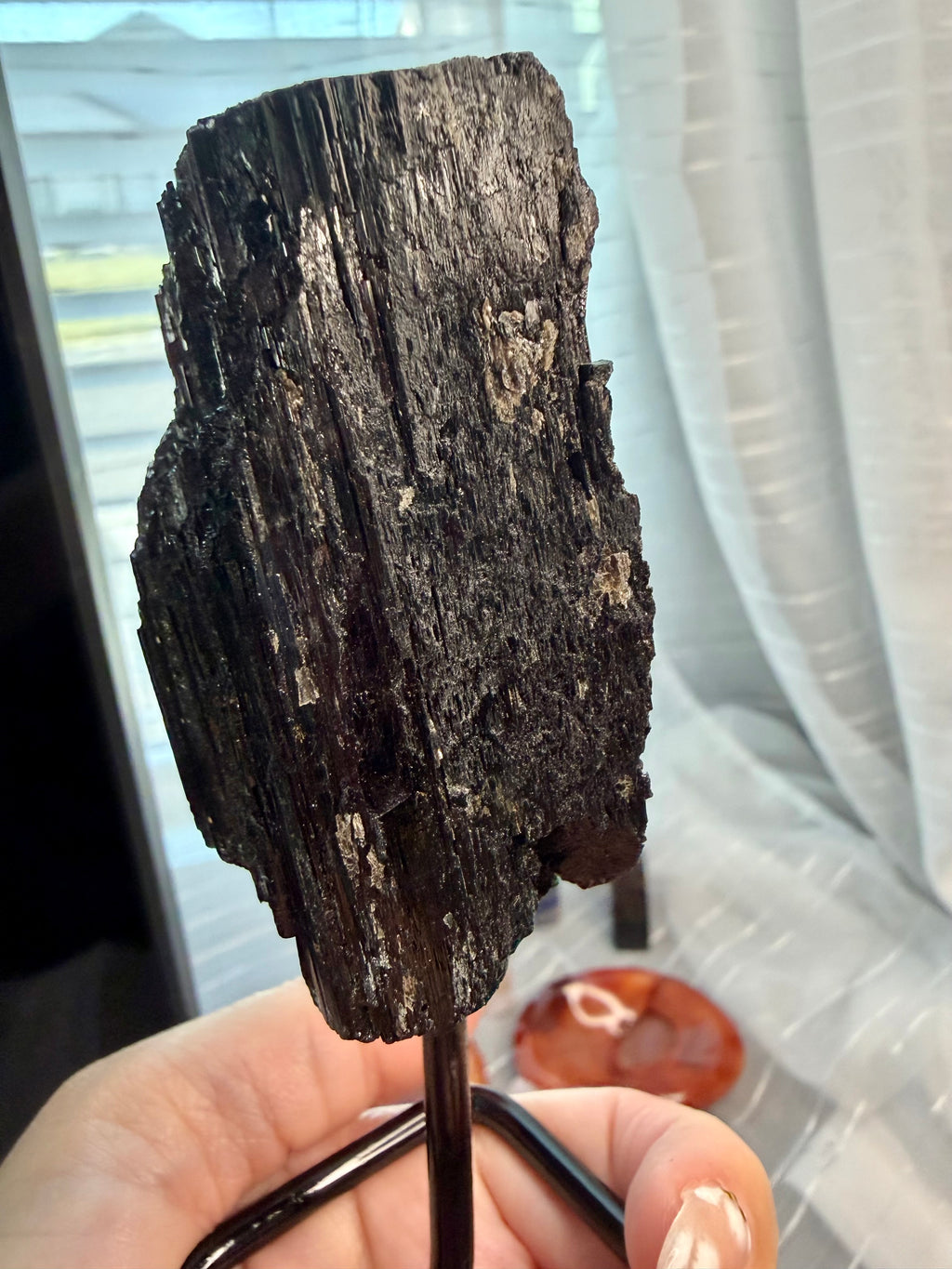 Black Natural Tourmaline mineral specimen mounted on fixed metal display pin.
