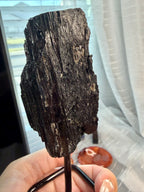 Black Natural Tourmaline mineral specimen mounted on fixed metal display pin.