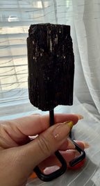Black Natural Tourmaline mineral specimen mounted on fixed metal display pin.