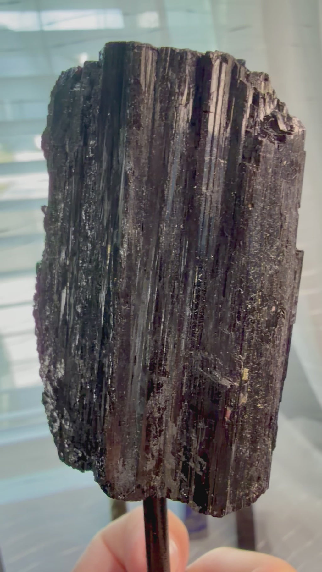 Black Natural Tourmaline mineral specimen mounted on fixed metal display pin.